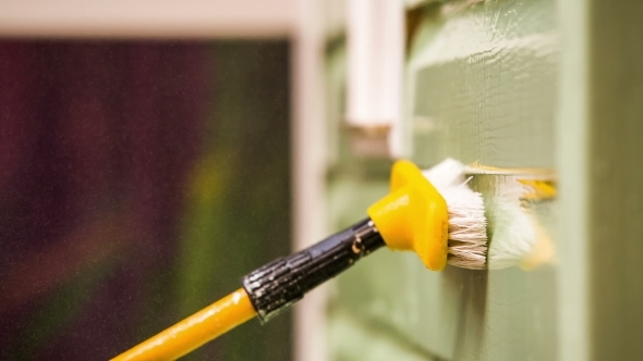 Person Washing House Wall With Jet Of Water And