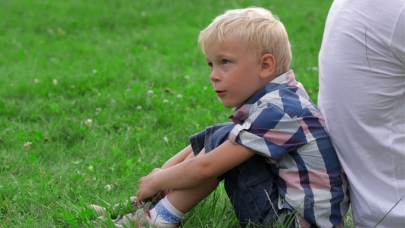 Father And Son Sitting Back To Back alt