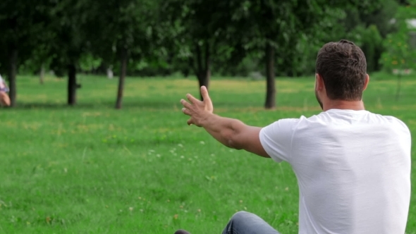 Father And Son Playing On The Grass In Park alt