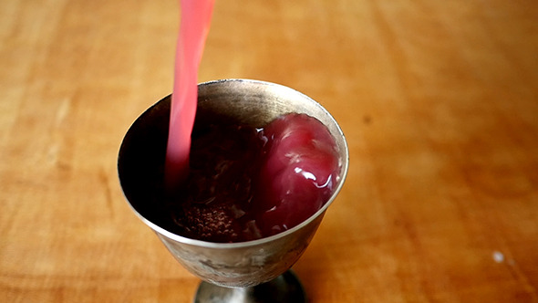 Pouring Wine Into Silver Old Cup