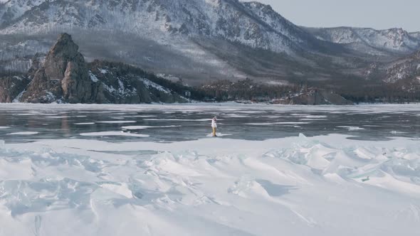 Aerial View of Man Skating on Lake Baikal Covered By Ice