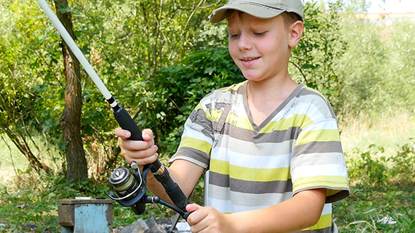 Boy Fishing With Spinning On River alt