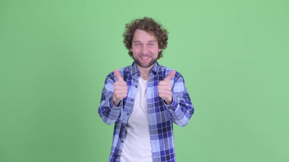 Happy Young Bearded Hipster Man Giving Thumbs Up and Looking Excited