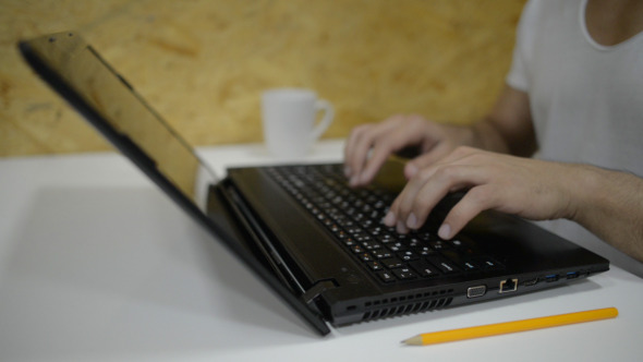 Casual Businessman Typing on Laptop Keyboard