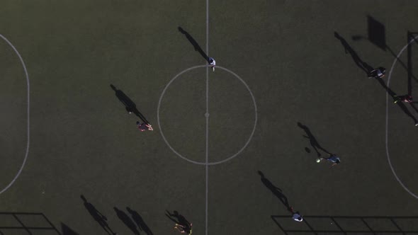 Top drone view of players in a football field in south Mexico City