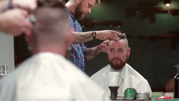 Beard Barber Making Haircut To Hipster Client alt