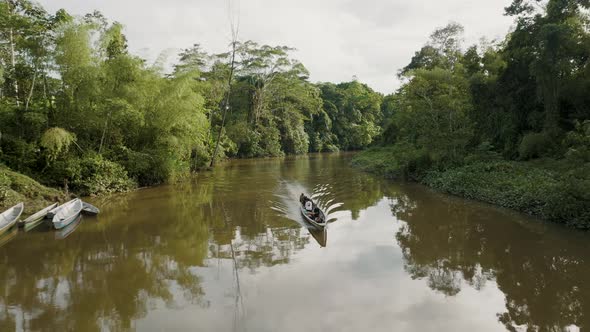 4k aerial drone backward shot of passenger boat sailing in the Amazon river. Sailing boat in the riv