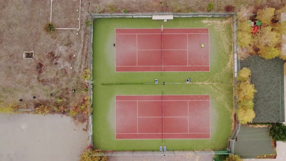 Aerial Top Down Drone Shot Rising Above People Playing Tennis