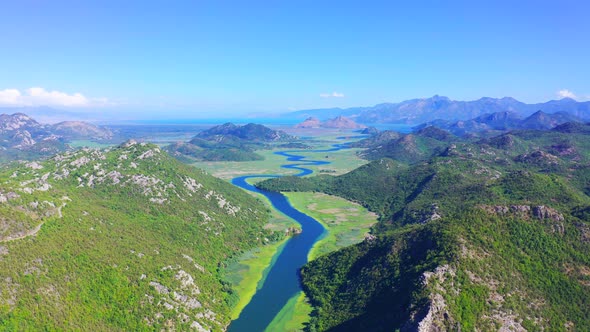 Blue River with Green Water Lilys on Mountains Background on Crnojevica River in National Park of