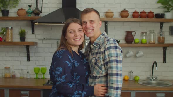 Portrait of Happy Proud Married Couple Holding Key to New Home Indoors