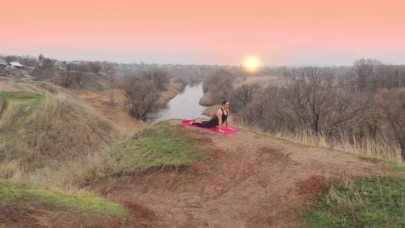 Young Woman Doing Yoga in Quiet Scenery