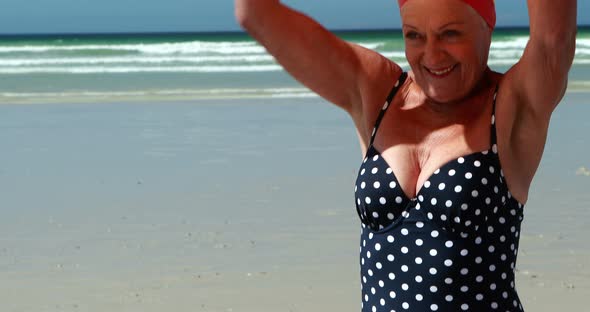 Senior woman with swim ring at the beach