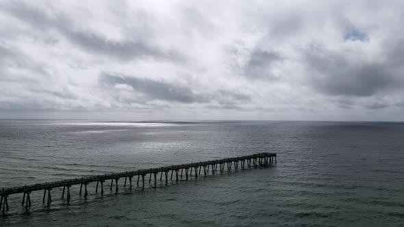 Gloomy Weather over Ocean Pier. Peaceful, Sad Vibes. Aerial Flying Drone View