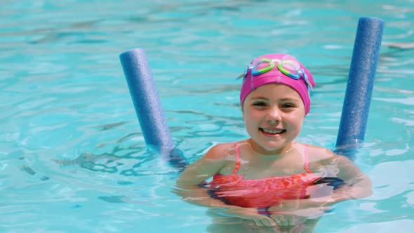 Portrait of young girl gesturing in the pool