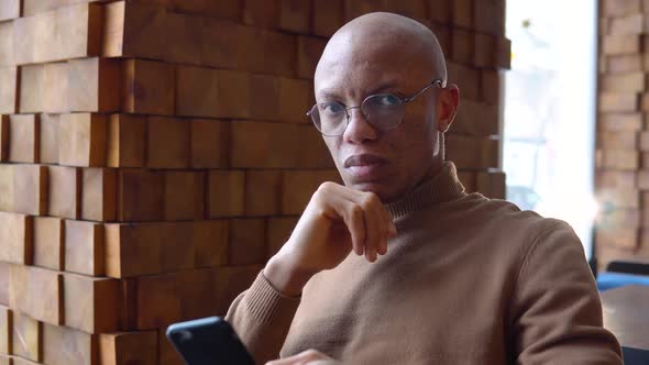 A Man with a Leadership Character Works Remotely in a Cafe