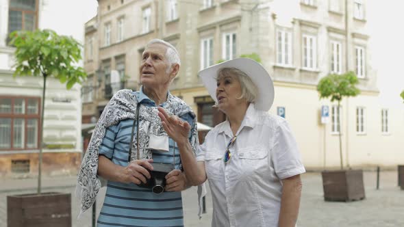 Senior Two Male and Female Tourists in City Center. Traveling in Lviv, Ukraine.