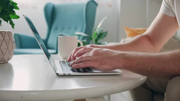 Hands Man Using Laptop Typing and Working at Home