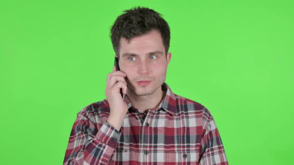 Portrait of Young Man Talking on Phone Green Chroma Screen