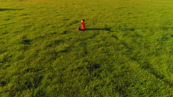 Low Altitude Radial Flight Over Sport Yoga Man at Perfect Green Grass. Sunset in Mountain