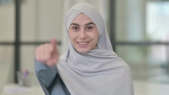 Young Arab Woman Pointing at the Camera