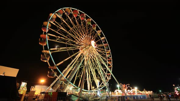 4k Time-lapse of Ferris Wheel at amusement park at a night time