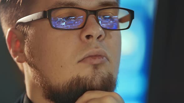 Young Man Working on Computer in Dark Digital Office