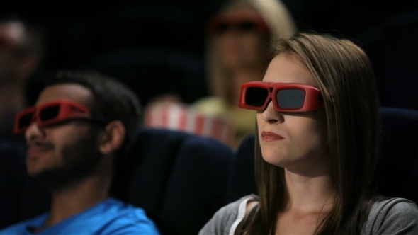 Group Of Friends Watching Film In Cinema alt