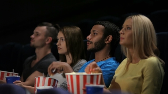 Group Of Friends Watching Film In Cinema alt
