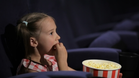 Beautiful Little Girl Waching Movie In The Cinema alt