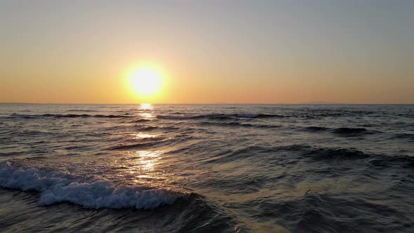 Tracking shot drone view at sunset of miditerranean sea of Sardinia, Italy