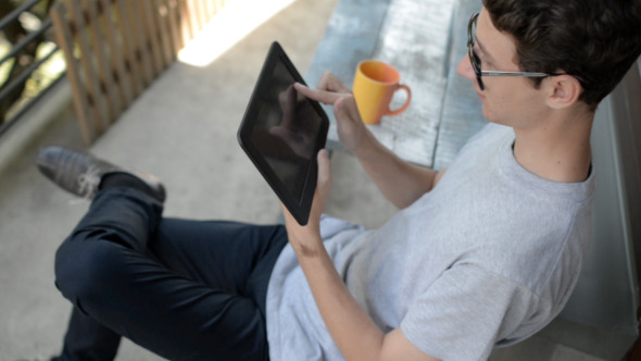 Young Man Using Tablet alt