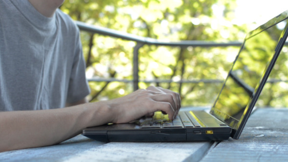 Working Hands on Laptop Keyboard alt