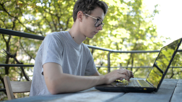 Working on Laptop Keyboard in Morning alt