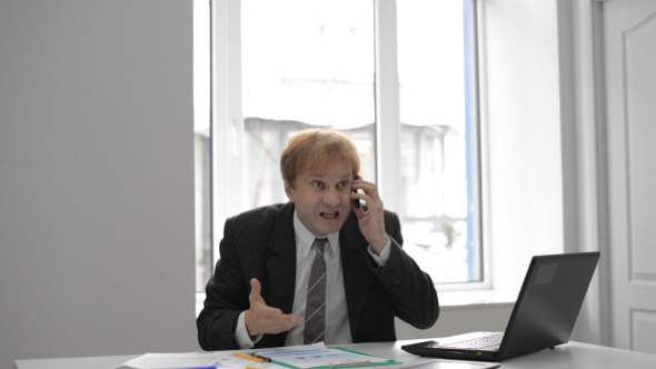 Angry Businessman on Phone Reacting Harsh