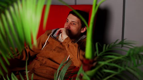 A Thoughtful Man Sitting in an Armchair