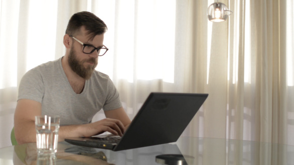 Man with Beard Using Laptop alt