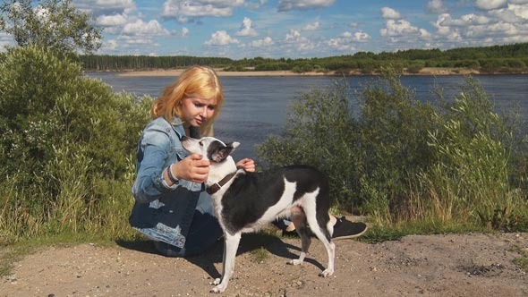 Girl With a Dog and a Telephone Near the River