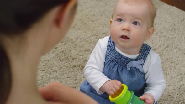 Baby Girl Listening Attentively to her Mom