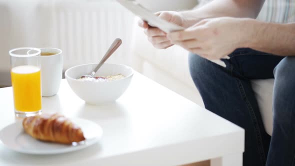 Close Up Of Man With Newspaper Having Breakfast 3