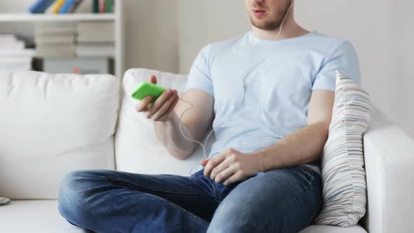 Close Up Of Man With Smartphone And Earphones 1