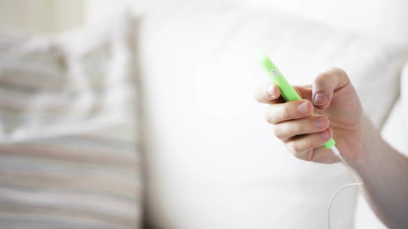 Close Up Of Man With Smartphone And Earphones 4