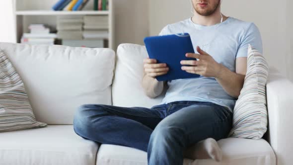 Close Up Of Man With Tablet Pc And Earphones 1