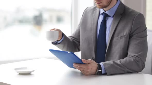 Close Up Of Man With Tablet Pc Drinking Coffee 1 alt