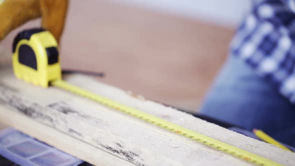 Close Up Of Man Hammering Nail To Wooden Board 10