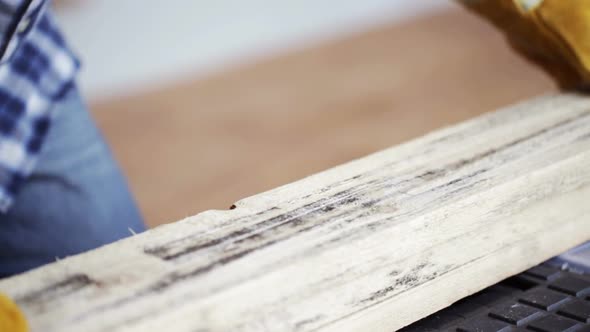 Close Up Of Man Hammering Nail To Wooden Board 12