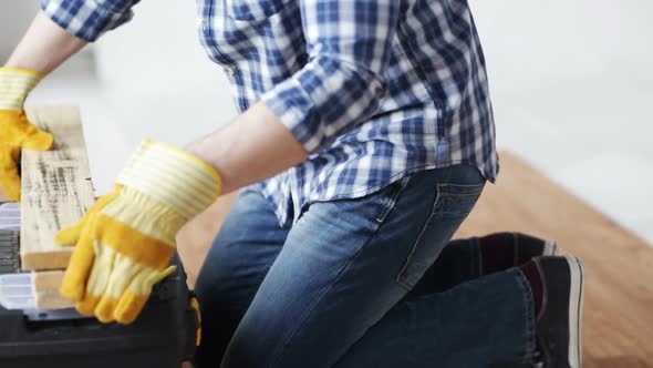 Close Up Of Man Hammering Nail To Wooden Board 6