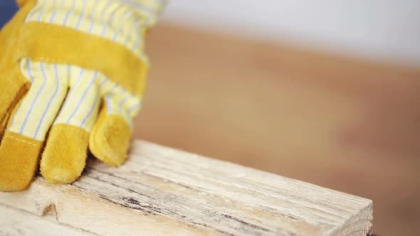 Close Up Of Man Hammering Nail To Wooden Board 8