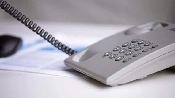 Close Up Of Businessman Hand Dialing Phone Number alt