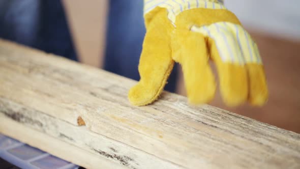 Close Up Of Man Hammering Nail To Wooden Board 9