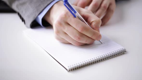 Close Up Of Businessman Hand Writing To Notepad 1 alt